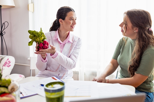 A Female Nutritionist in Her Clinic Provides Professional Nutritional Guidance