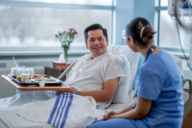 A nurse helping a male patient understand recovery after bariatric surgery in Middleburg Heights, OH