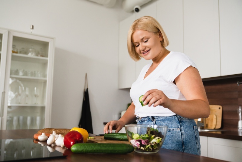 A Woman is Preparing Vegetables in Her Kitchen for Healthy Weight Loss in Middleburg Heights, OH
